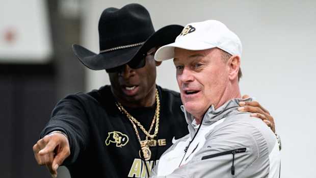 Deion Sanders talks to Rick George at CU practice